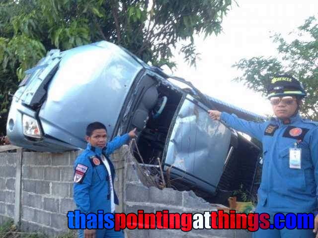 A scene from an incident in the media in Thailand, with men pointing at an overturned car - photo via ThaisPointingAtThings.com