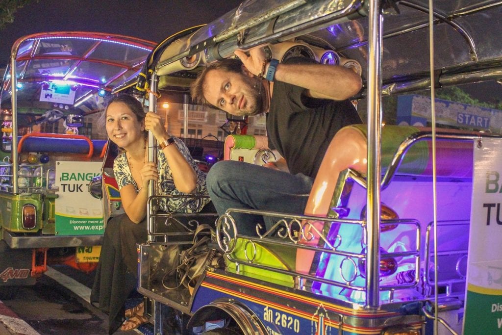 Guests posing in a tuk tuk