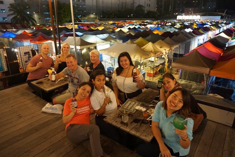Guests enjoying a drink overlooking Racthada Train market