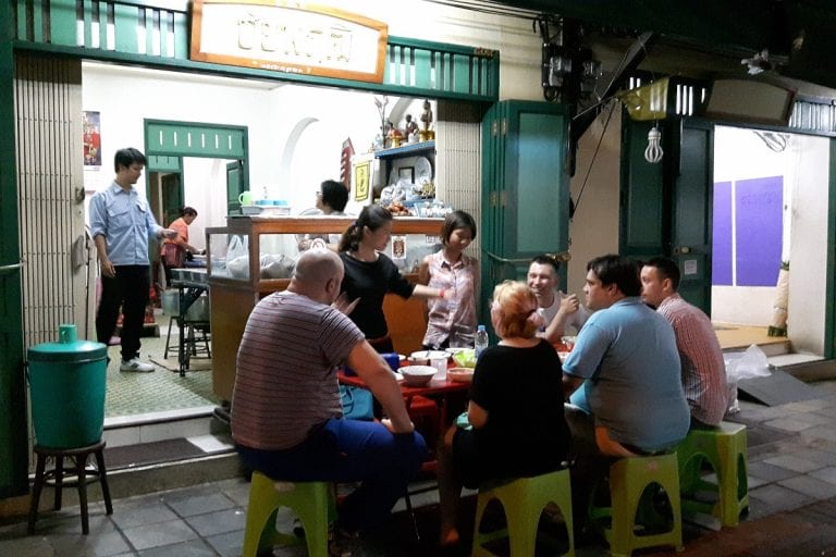 Guests enjoying local street food on a Bangkok Food Tour
