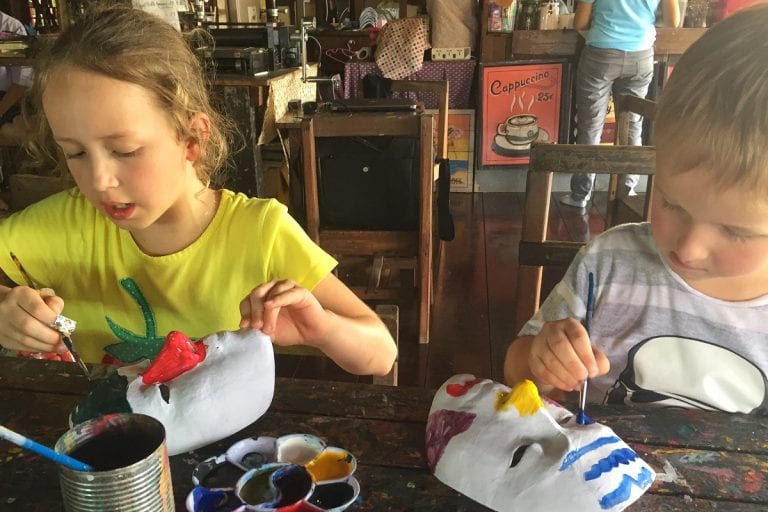 Kids painting Thai masks at Baan Silapin