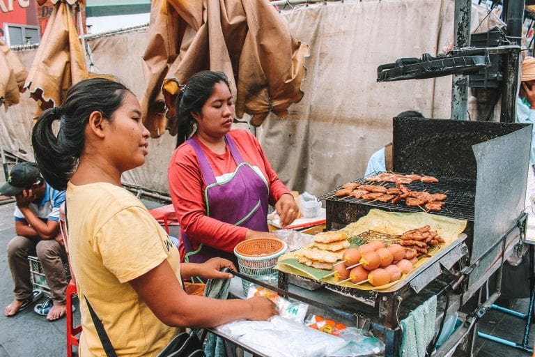 Street food vendor selling grilled pork and grilled egg