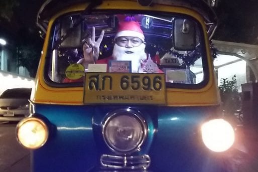 Santa drives a tuk tuk in Bangkok
