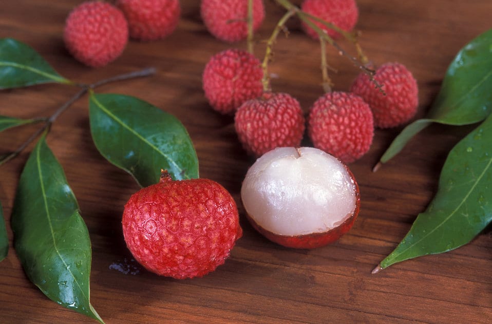 Image of peeled lychee with red shells and a white fresh