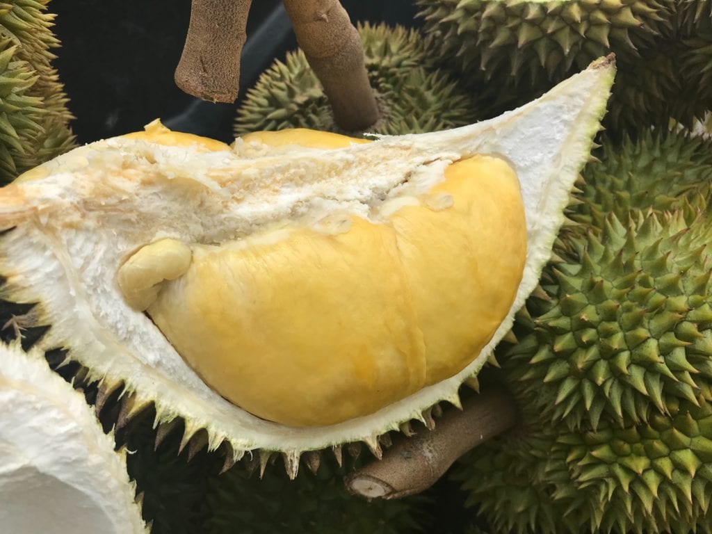 Image of a peeled durian showing yellow fresh inside