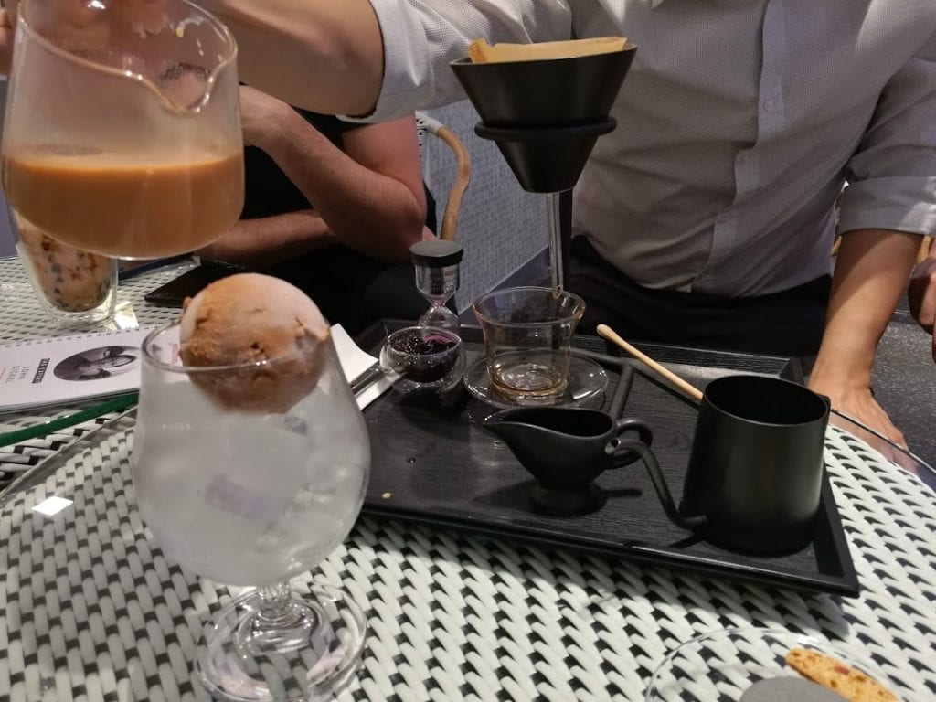 Pour-over tea served with ice cream in a mall shop