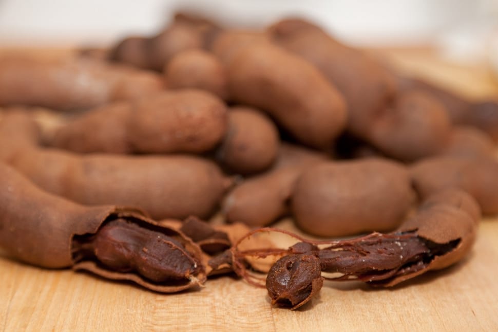 Thai fruit: cracked brown tamarinds is  with their fresh