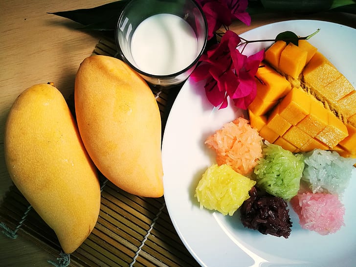 Image of yellow ripe mango with coloureful sticky rice plus coconut milk