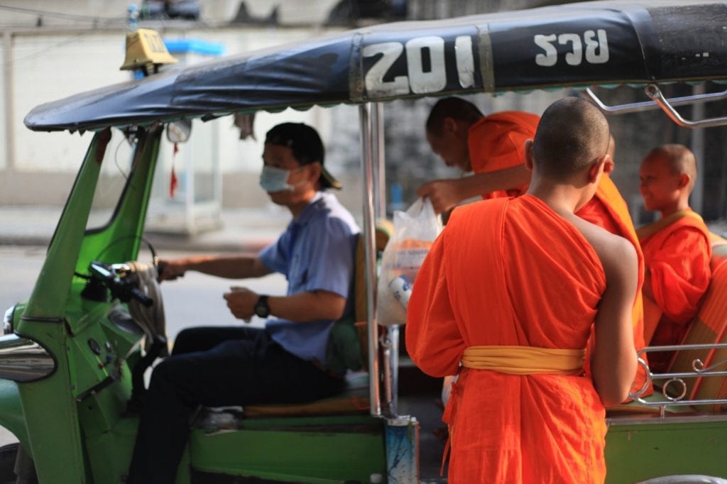 Monks taking a tuktuk