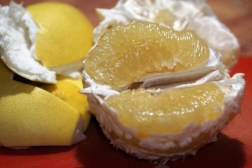Image of pomelo's fresh with its yellow shell beside