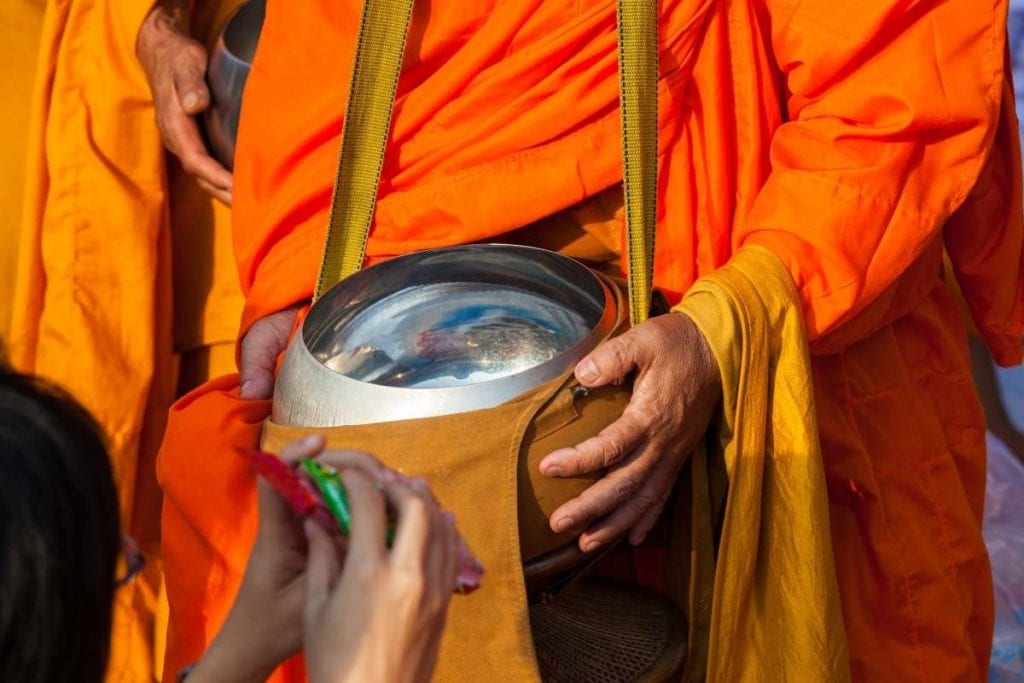 Early morning alms giving to monks